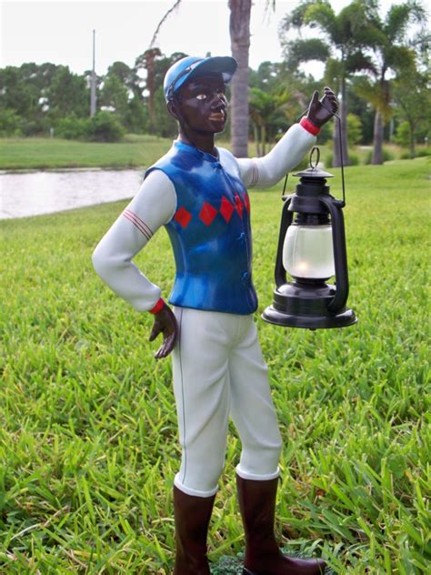 black statue holding a lantern|More.